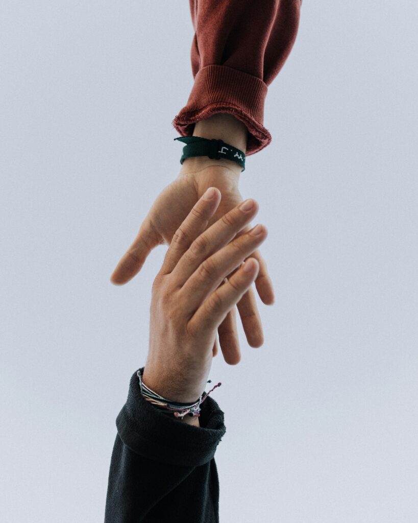 Close-up shot of two hands reaching for each other and almost holding mid-air