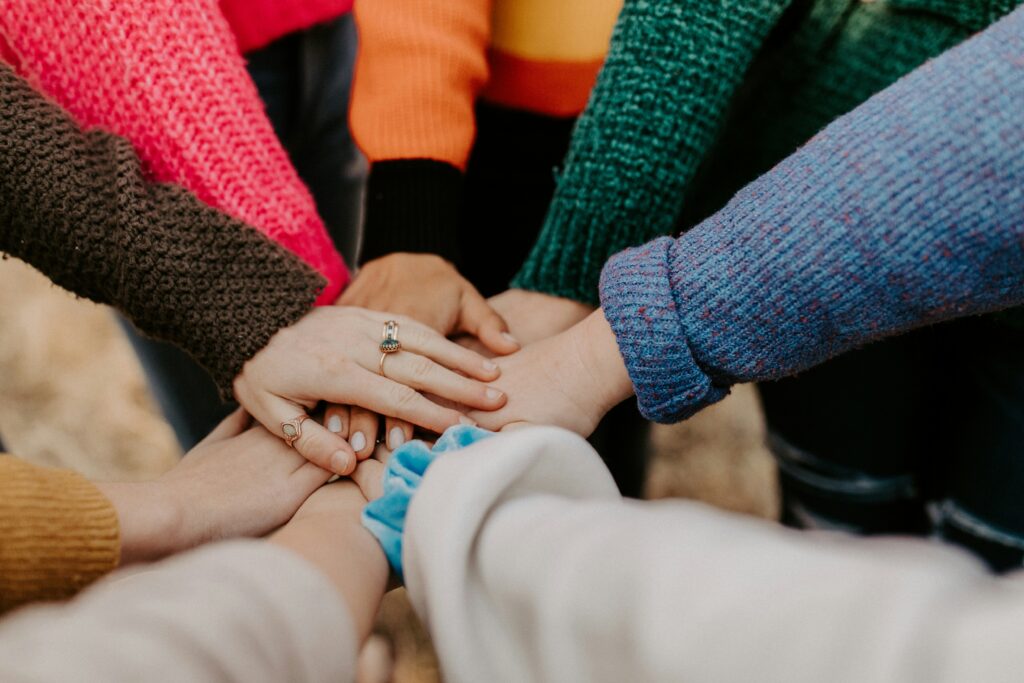 Close-up shot of a hand stack of various young hands