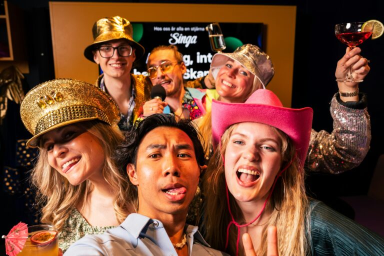 People at a corporate event taking photos with props