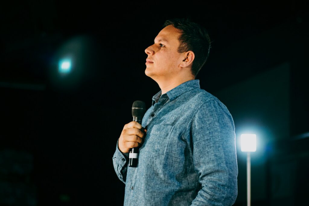 A man holding a microphone on the stage